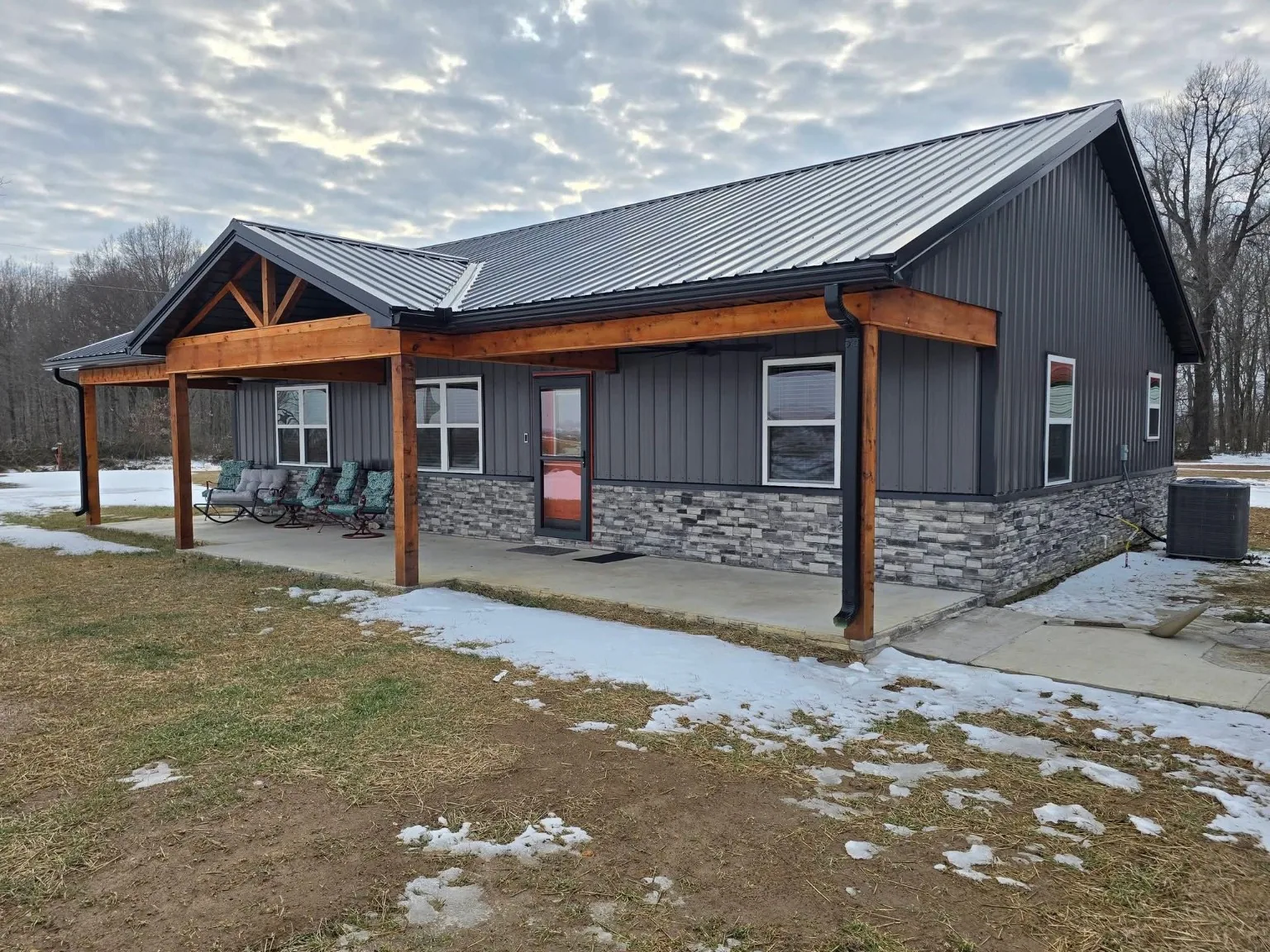 Finished Cornerstone new-construction home with timber porch