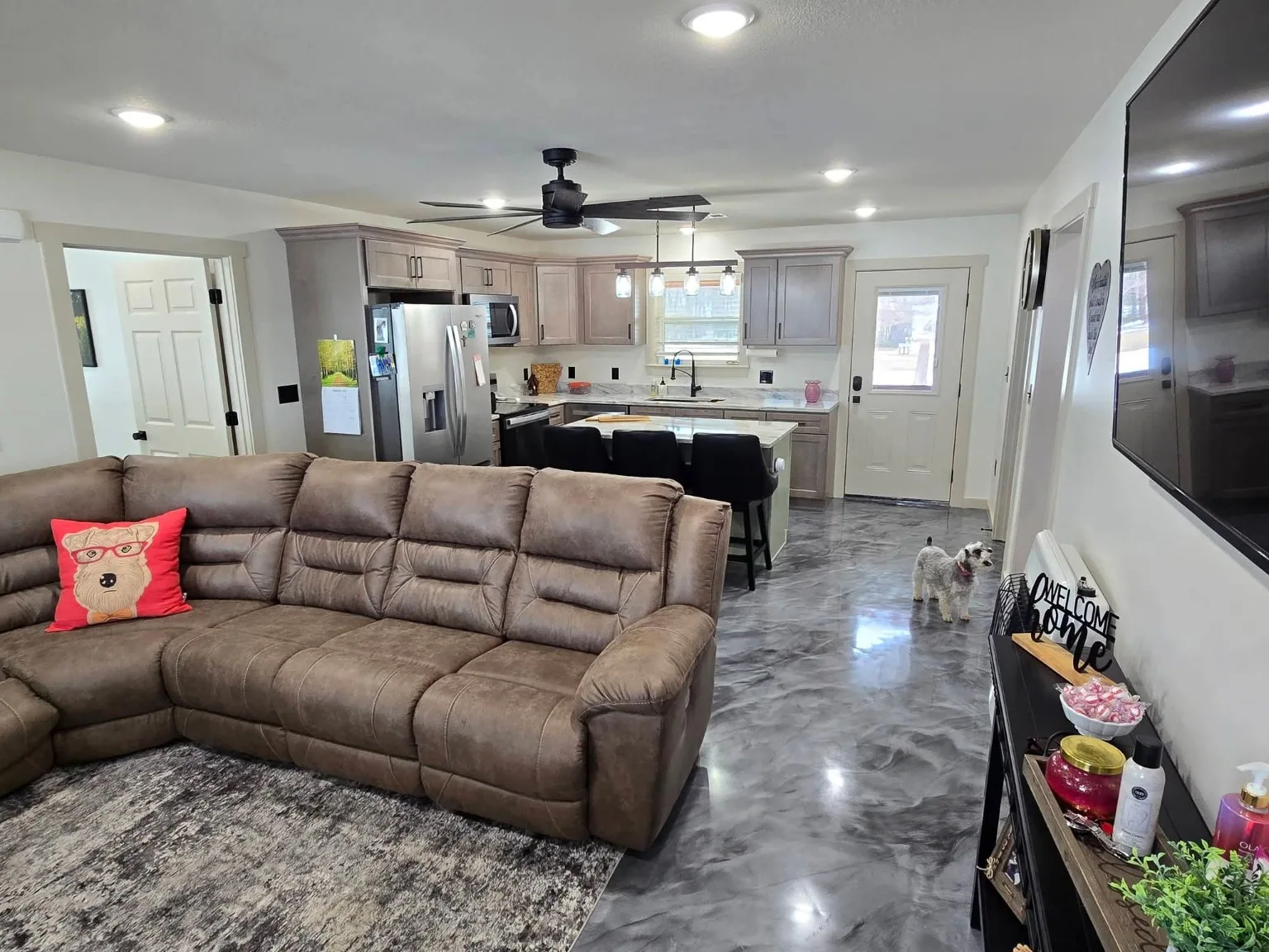 Open concept living room and kitchen in completed home