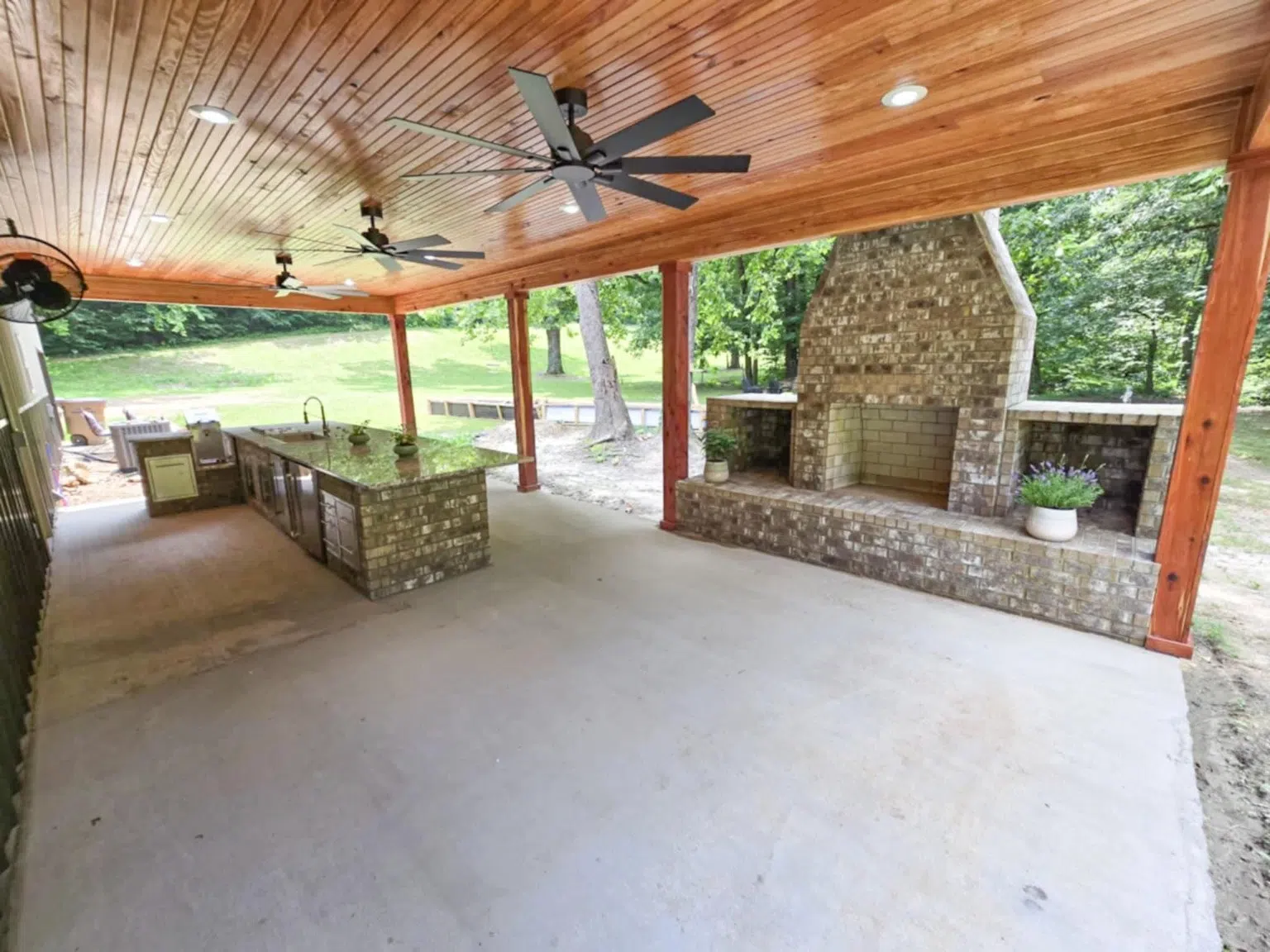 Brick built-in outdoor kitchen under covered patio