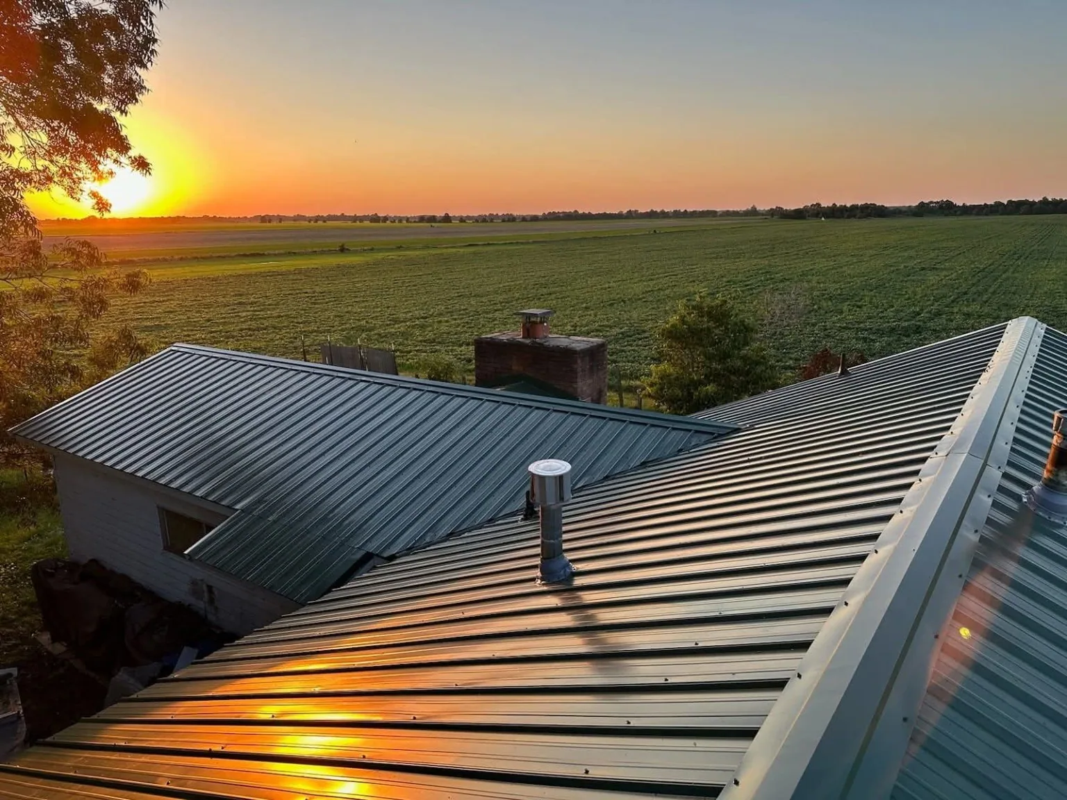 Residential metal roof at sunset