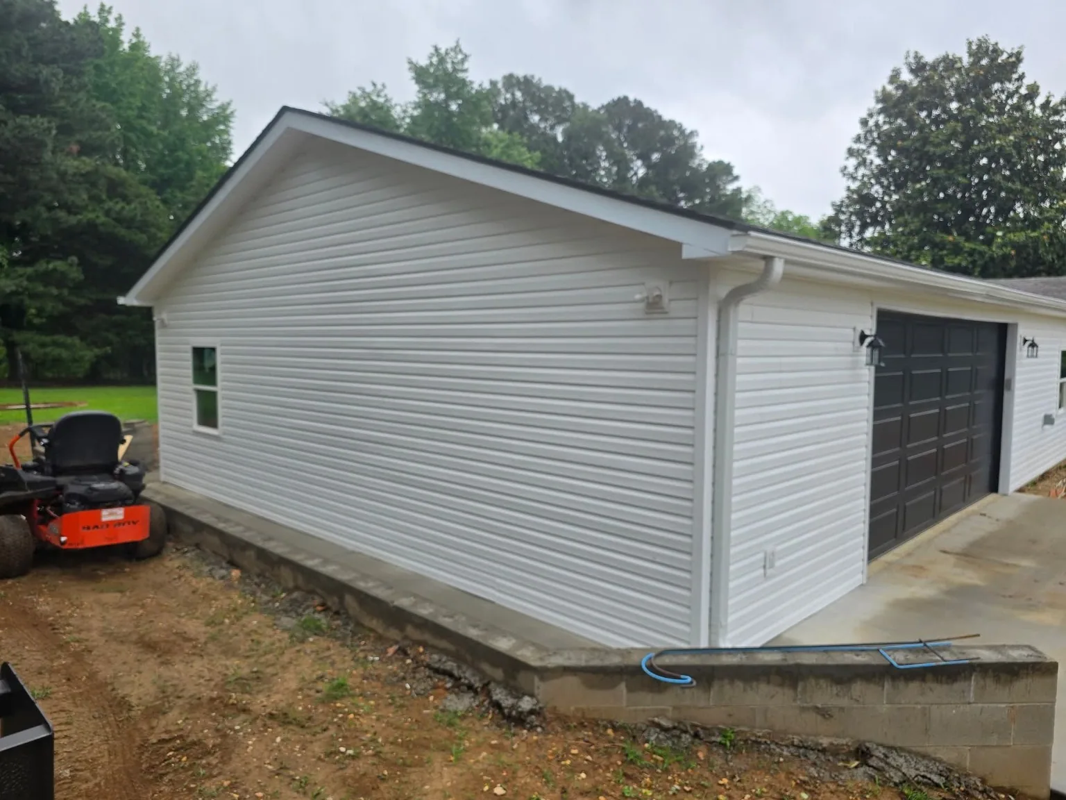 White attached garage addition side view